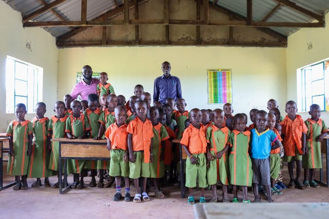 Teacher with children in a rural Kenya classroom