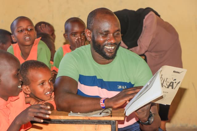 LCI founder with community members in rural Kenya